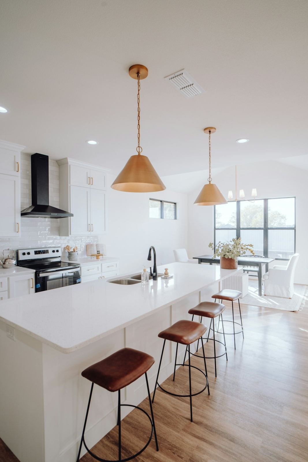A clean kitchen with a large island and clear counters